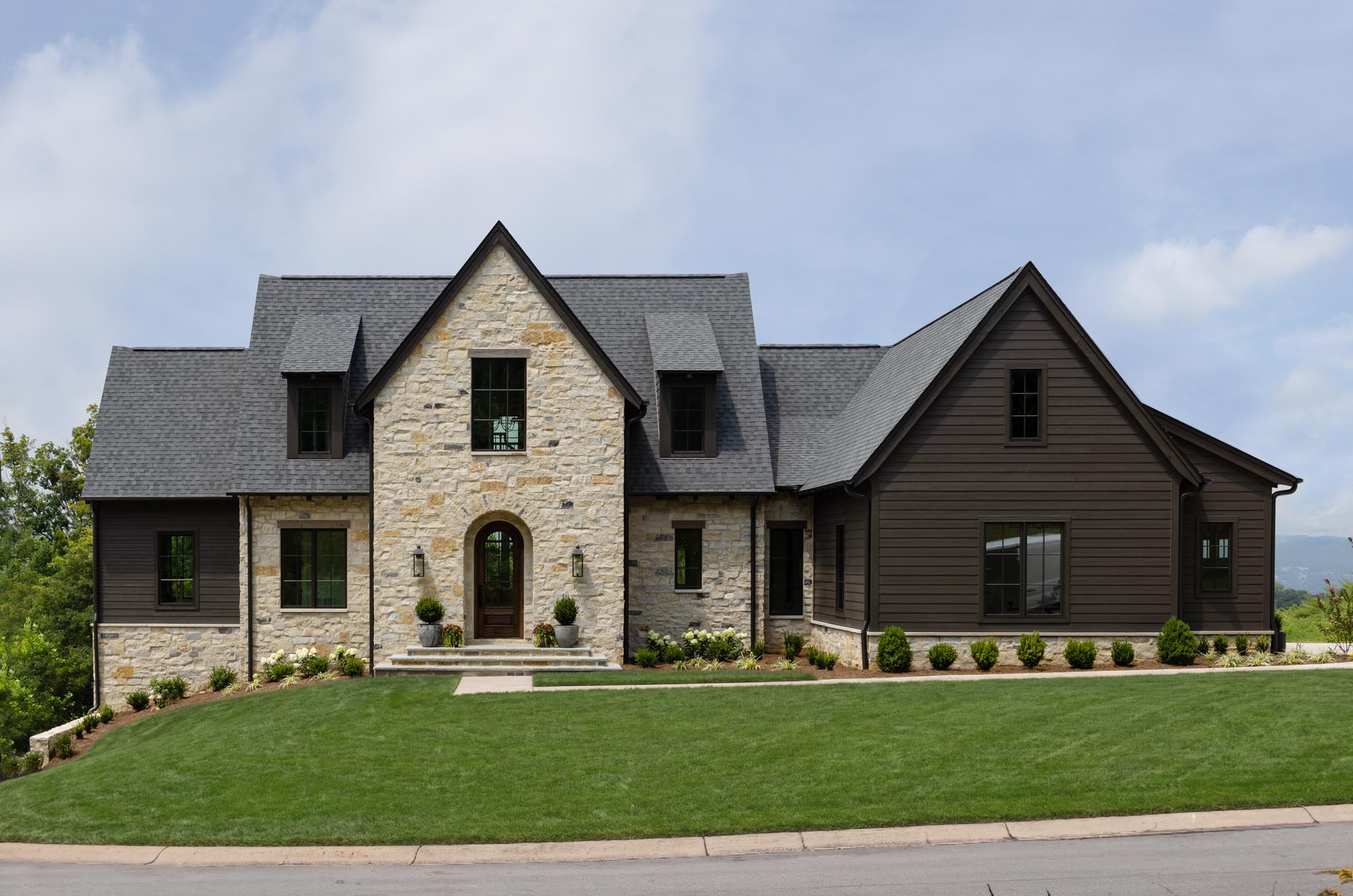 Full front elevation of the Summit house with natural stone exterior