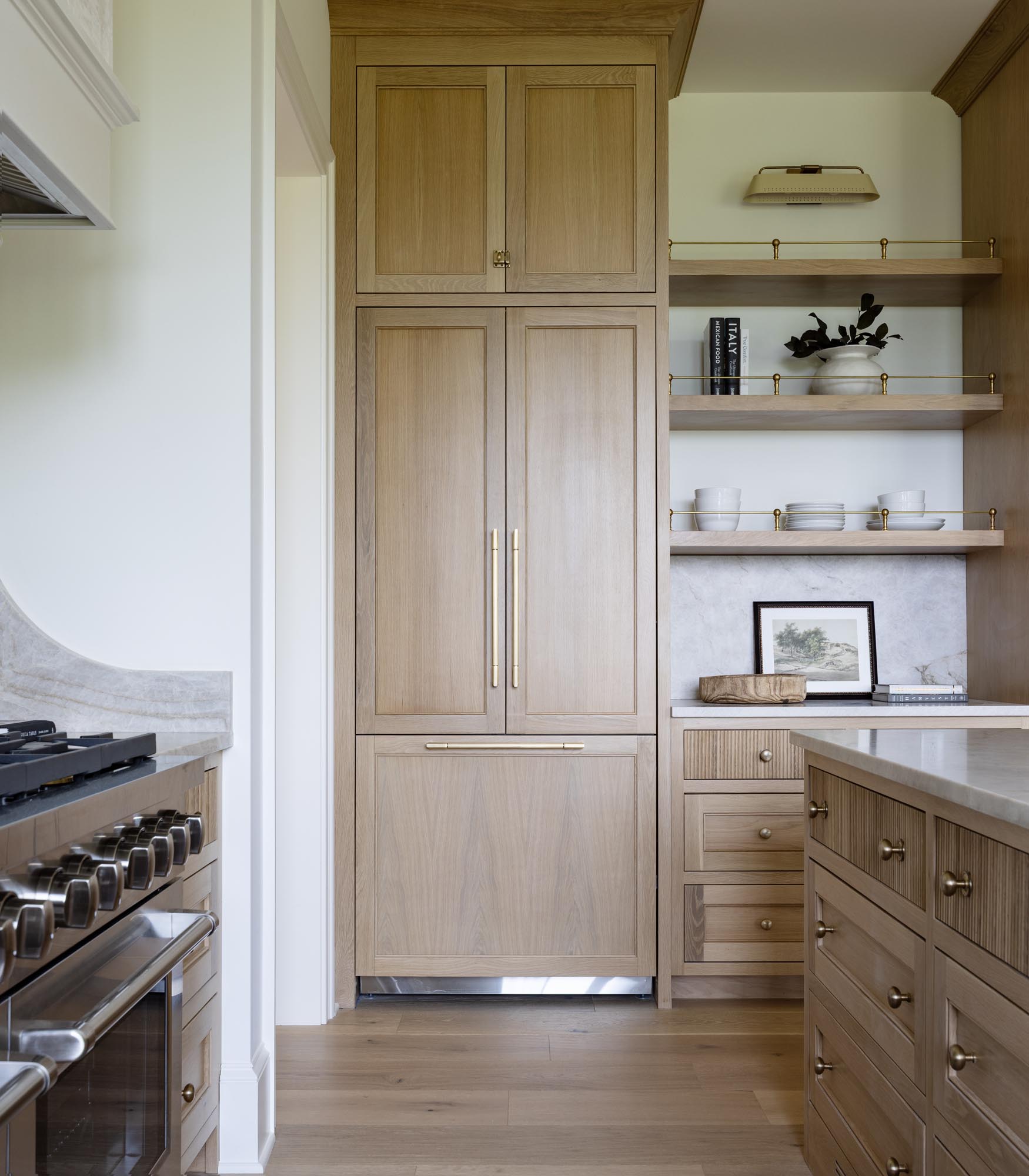 ZLINE panel-ready refrigerator with Brass and Ivory white oak panels and Signature Hardware Lunata brass pulls
