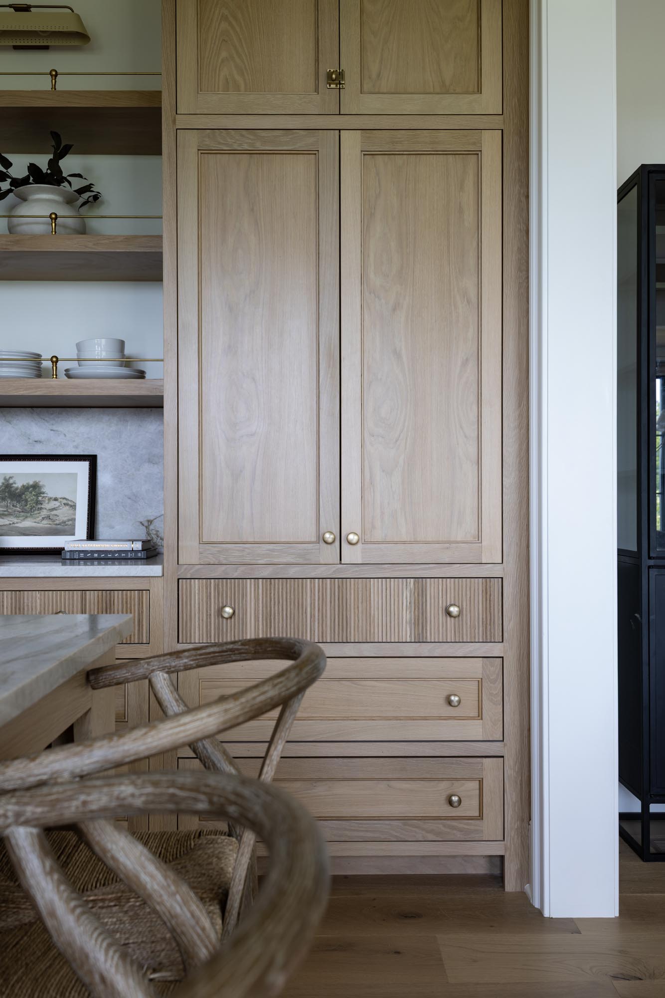 Tall white oak pantry cabinet with inset doors, reeded drawer and Grandeur Fifth Avenue brass knobs